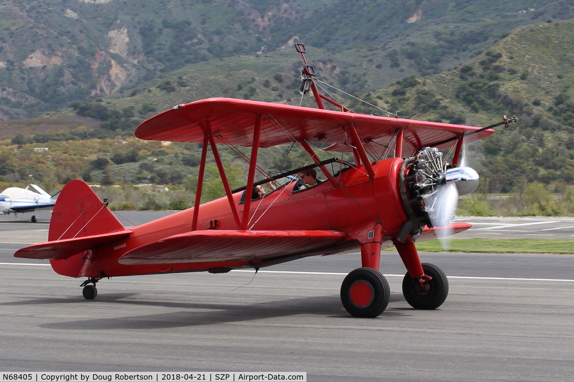 N68405, 1943 Boeing A75N1(PT17) C/N 75-7759, 1943 Boeing Stearman A75N1 (PT-17), P&W R-985 Wasp Jr. 450 Hp upgrade, taxi off Rwy 22. Wing rider has climbed down into rear cockpit.