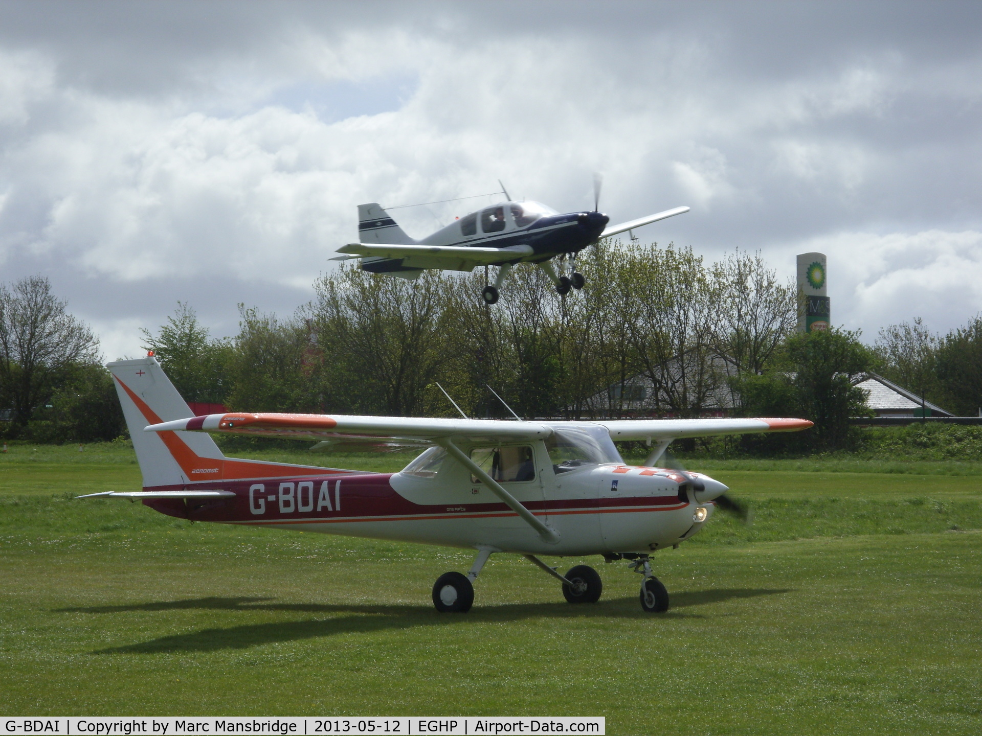 G-BDAI, 1975 Reims F150M C/N 0266, Taxiing out at Popham airfield with G-AZEV landing behind