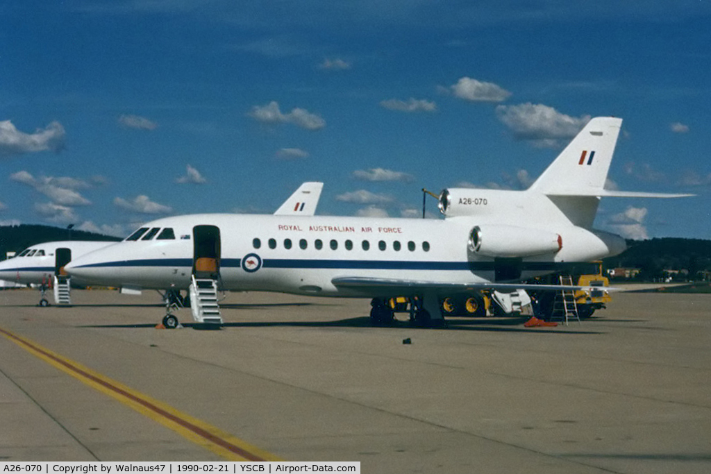 A26-070, 1989 Dassault Falcon 900 C/N 070, Port side view of RAAF 34 Squadron Falcon 900 A26-070 Cn 070 (and 'Sister-Ship' A26-076 at rear) at her RAAF Fairbairn 'home-base' in 1990. The five F900s were replaced by two Boeing B737 BBJs, and three Challengers in 2002.