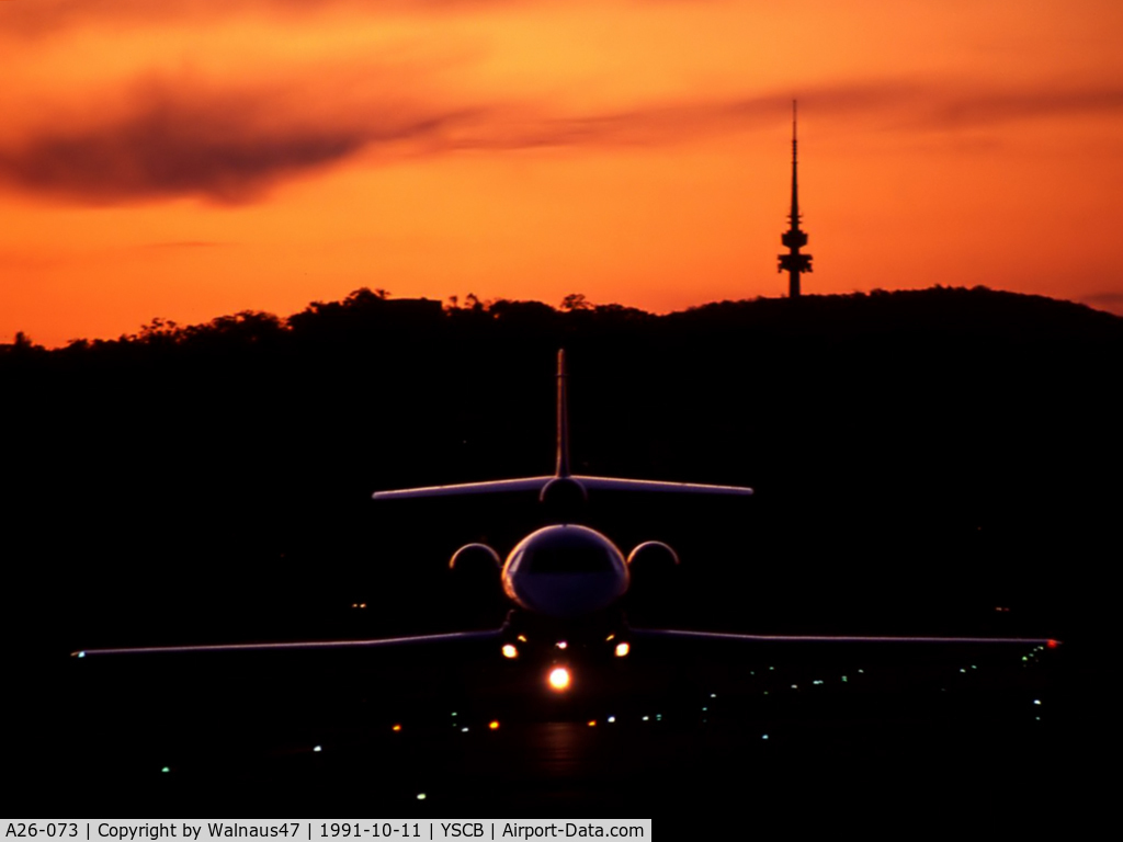 A26-073, 1989 Dassault Falcon 900 C/N 073, Low res ‘silhouette’ photo of 34 Squadron VIP Falcon 900 A26-073 Cn 073 taxying in (with Lights On) from Canberra's Rwy 35 after sunset on 11Oct1991. (Telstra Tower on Black Mountain is visible at rear, matching the F900 tail fin.)