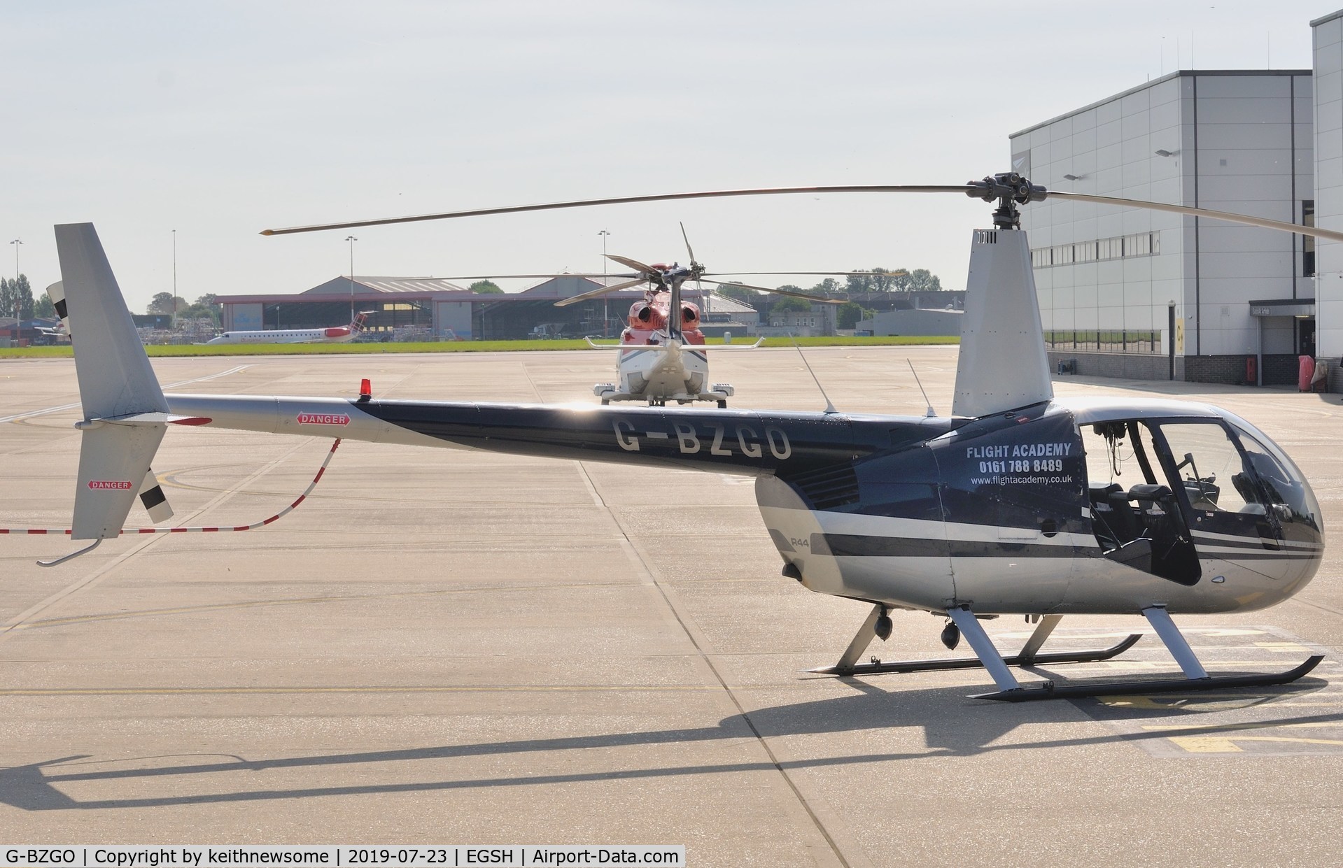 G-BZGO, 2000 Robinson R44 Astro C/N 0757, Parked at Norwich with door removed.