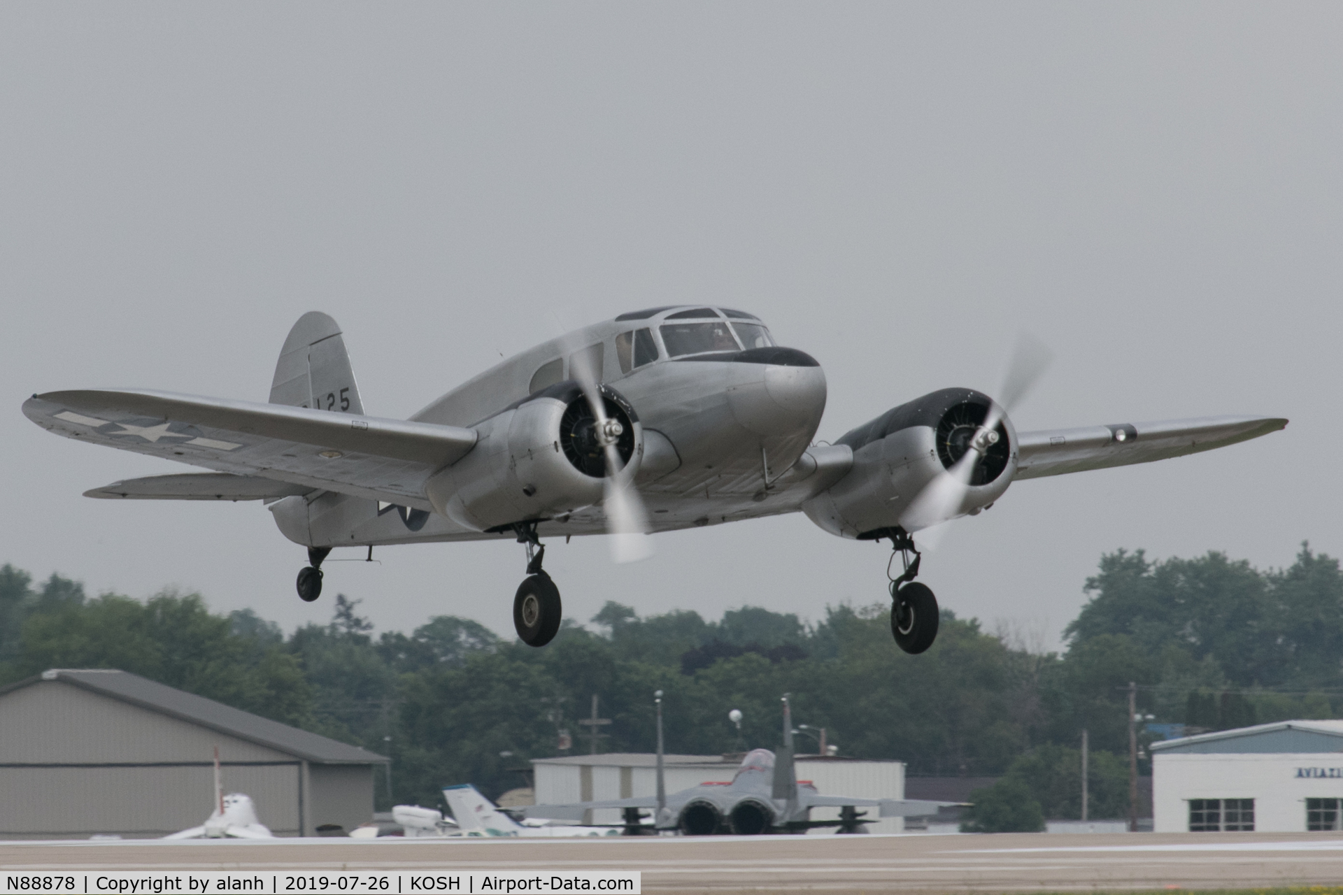 N88878, 1943 Cessna UC-78C (T-50) Bobcat C/N 4121, Taking off to display on a rare grey day at AirVenture 2019. This picture dedicated to my late friend Geoff Jones whose third attempt to photograph this aircraft air-to-air was foiled by reluctant engines.