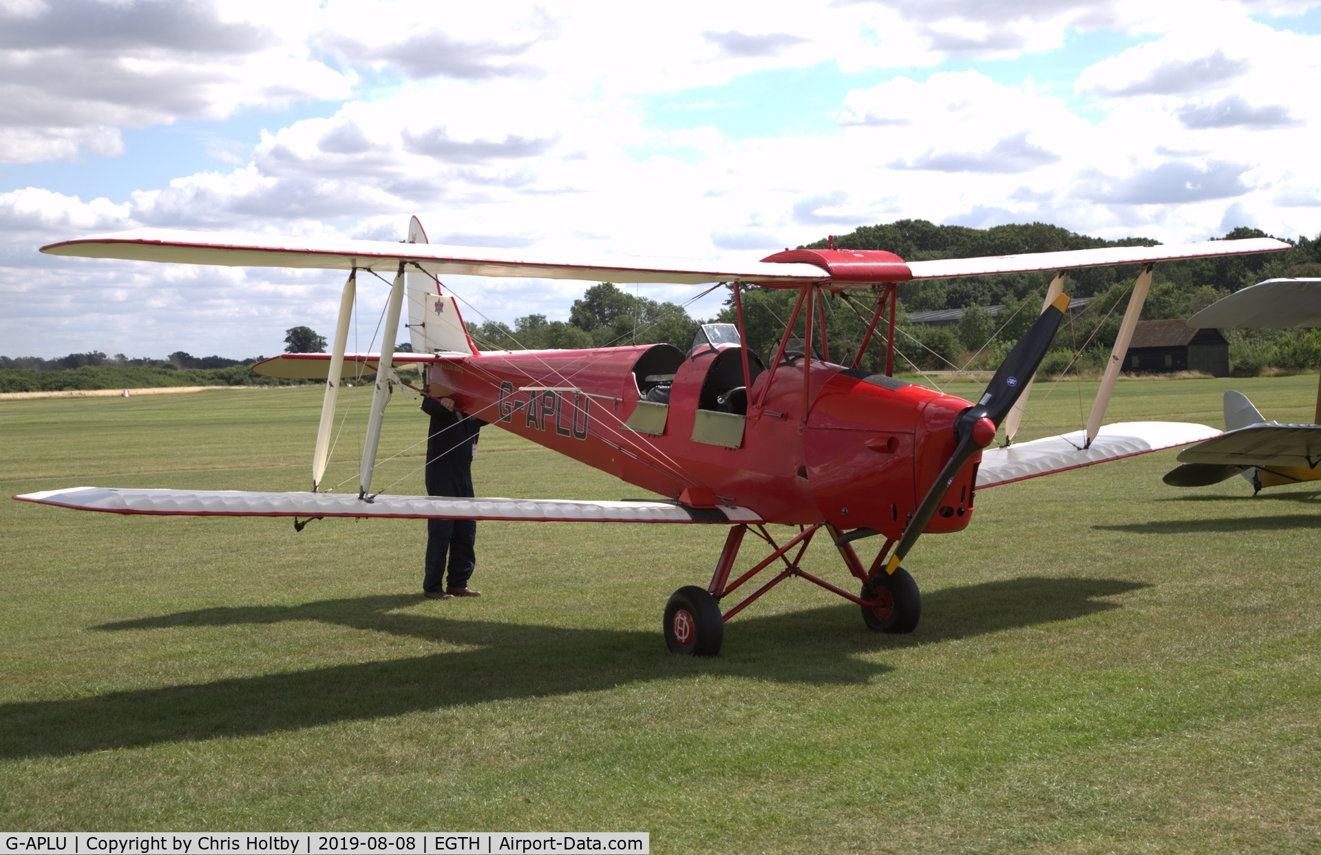 G-APLU, 1941 De Havilland DH-82A Tiger Moth II C/N 85094, 1941 Tiger Moth being manually lifted and turned for taxiing at the 'Gathering of Moths' Day 2019 at Old Warden