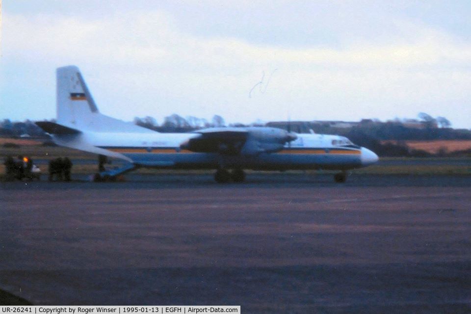 UR-26241, 1977 Antonov An-26 C/N 909, A poor photo of Busol Airlines An-26 aircraft visiting Swansea Airport at dusk on 13th January 1995.