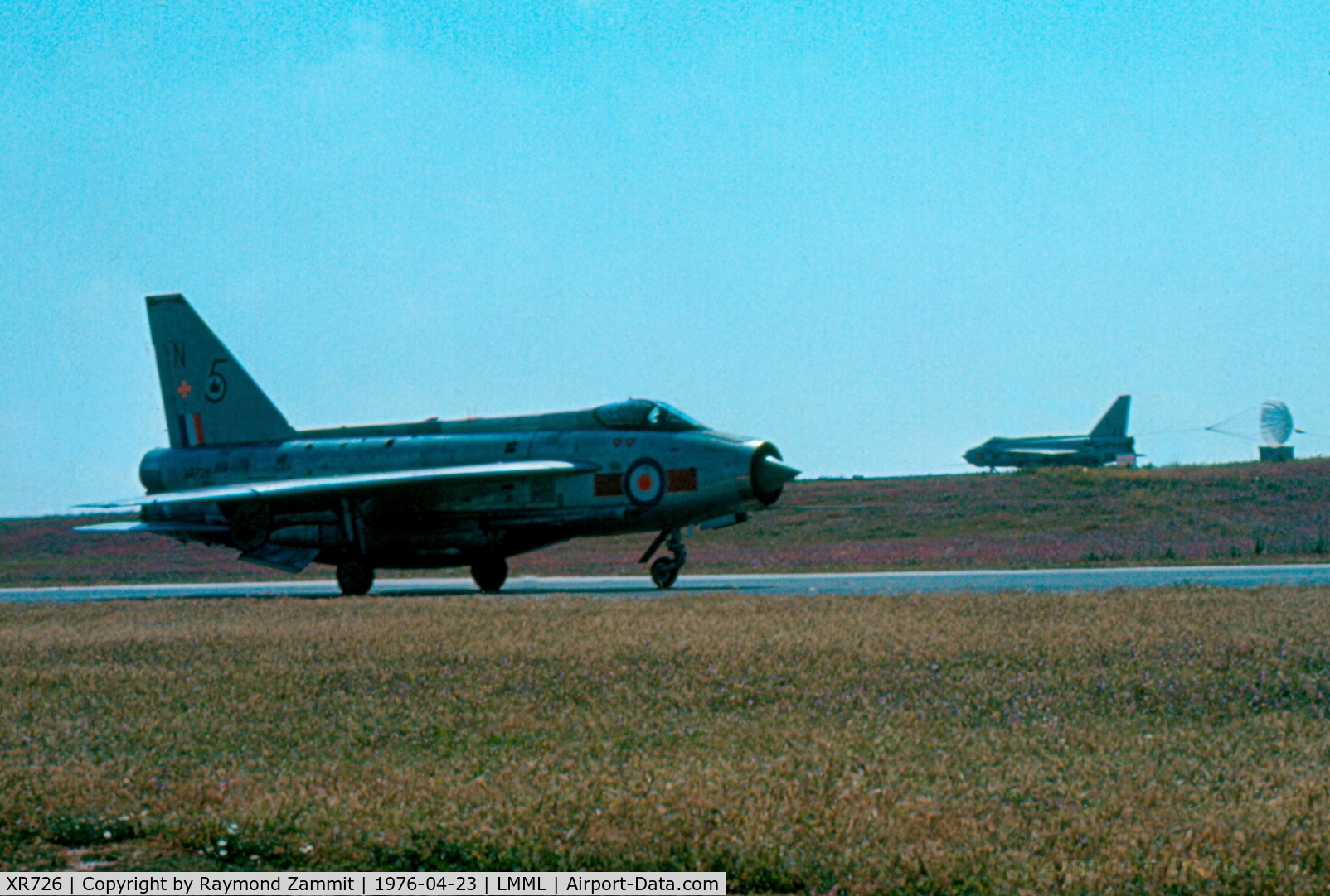 XR726, 1965 English Electric Lightning F.6 C/N 95209, E.E Lightning F.6 XR726/N 5Sqdn Royal Air Force seen taxying out for the sortie while a company aircraft is seen streaming on the runway on landing.