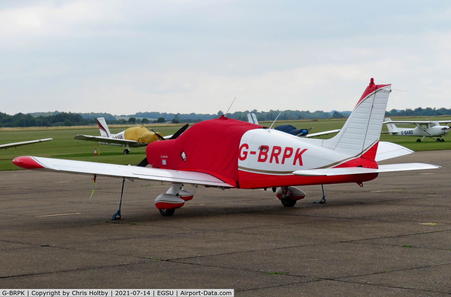 G-BRPK, 1972 Piper PA-28-140 Cherokee C/N 28-7325070, Parked and covered at Duxford Airfield Cambs.