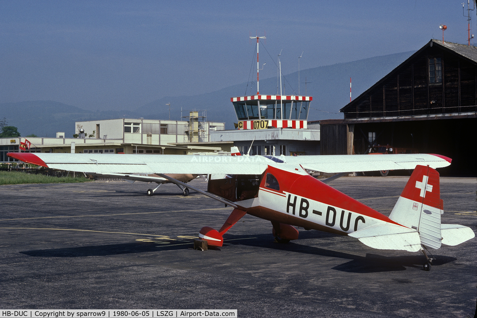 HB-DUC, 1948 Luscombe 8F Silvaire C/N 6295, At grenchen, with the old tower and hangar, before leaving for Denmark. Scanned from a slide.
