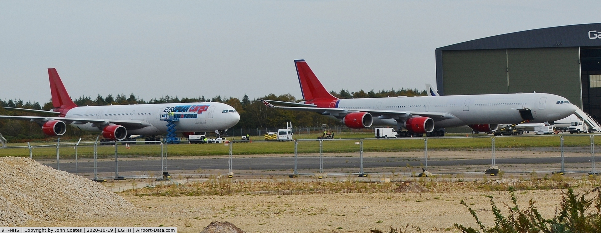 9H-NHS, 2006 Airbus A340-642 C/N 736, Waiting with 9H-EAL for new European Cargo titles to be applied