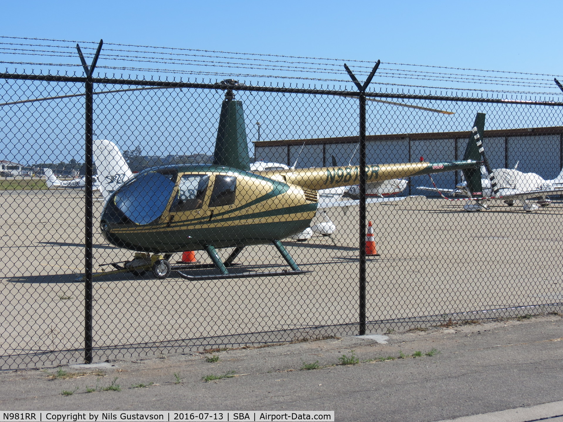 N981RR, 2001 Robinson R44 Raven C/N 0961, Parked at Santa Barbara Airport. Crashed in Santa Barbara, CA on 05/15/2017 while on a Sightseeing Tour. All three people aboard survived.