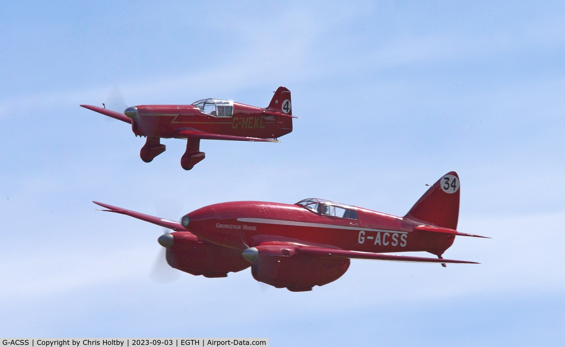 G-ACSS, 1934 De Havilland DH-88 Comet C/N 1996, Flying in a pair with replica Mew Gull (G-HEKL) at the Vintage Airshow at Old Warden 2023
