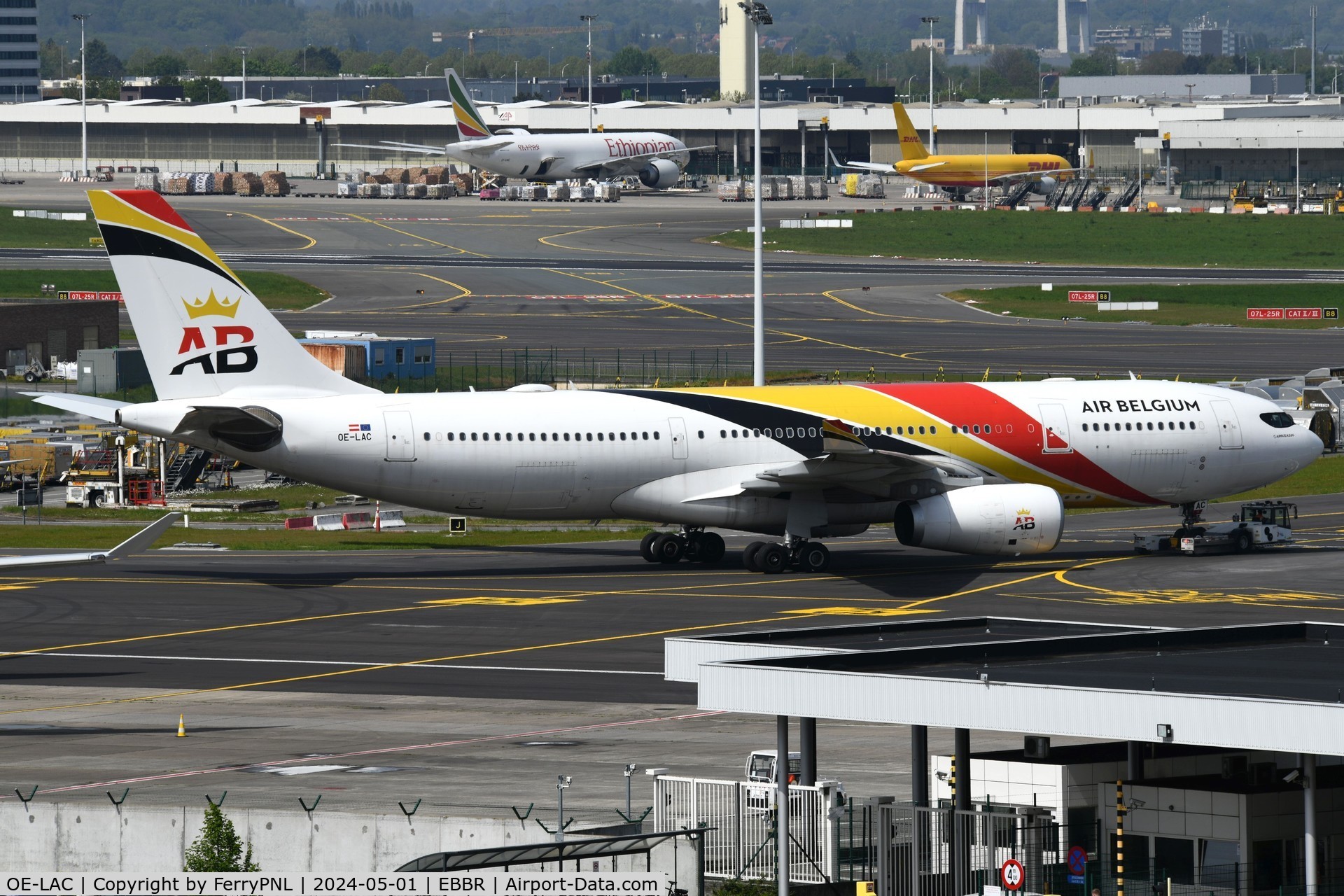 OE-LAC, 2013 Airbus A330-243 C/N 1486, Air Belgium being towed to the maintenance area on the other side of the field
