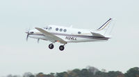 N124LL @ PDK - Departing PDK - Starting to rotate gear. - by Michael Martin
