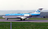 PH-KZH @ BRS - KLM Fokker 70 with reverse thrust applied after touchdown at Bristol Airport, Bristol, England May 2004 - by Adrian Pingstone