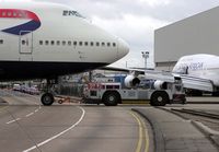 G-CIVC @ LHR - A ground-handling tug pulls a British Airways Boeing 747-400 (G-CIVC) across a public road at London (Heathrow) Airport, England in January 2005 - by Adrian Pingstone