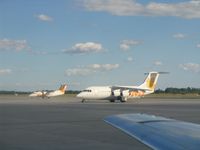C-GRNX @ YOW - BAe 146 and Dash 8, both in the yellow Air Canada Jazz colour scheme, see over the wing of JetsGo's F100 C-GKZA - by Micha Lueck