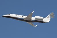 N928CW @ LAX - N928CW - Embraer ERJ-135BJ Legacy departing LAX RWY 25R on a clear February afternoon. - by Dean Heald
