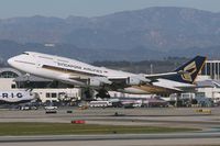 9V-SPL @ LAX - Singapore Airlines - 9V-SPL (747-412) departing LAX RWY 25R. - by Dean Heald