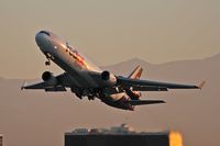 N584FE @ LAX - FedEX N584FE departing LAX RWY 25L on an early morning in November. - by Dean Heald