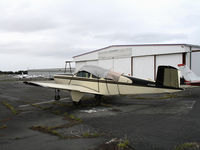 N728HM @ HWD - 1955 Beech C35 sans prop & under tarp at stormy Hayward Air Terminal, CA - by Steve Nation