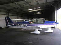 G-BYNK @ EGLA - Robin HR100 in the hangar at Bodmin - by Simon Palmer