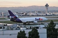 N312FE @ LAX - FedEx N312FE taxiing to the cargo terminal after arrival on RWY 25L on a clear February evening. - by Dean Heald