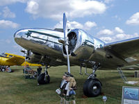 N99K @ OSH - highly polished Lockheed 12A at Airventure - by Jim Uber