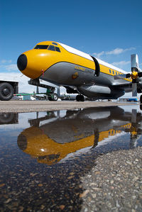 C-GHZI @ CYQF - Air Spray Lockheed Electra - reflection - by Yakfreak - VAP