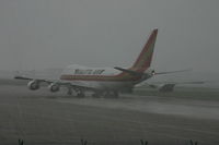 N704CK @ BRU - departing under hail storm - by Daniel Vanderauwera
