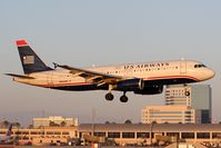 N662AW @ SNA - US Airways (America West Airlines) N662AW (FLT AWE133) from Las Vegas McCarran Int'l (KLAS) on short-final to RWY 19R in nice evening light. - by Dean Heald