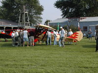 N68N @ IA27 - A crowd gathers round the rare Golden Eagle Chief shortly after landing at Antique Airfield near Blakesburg, IA during the 2004 AAA/APM National Fly-in - by BTBFlyboy