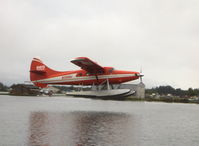 N2899J @ LHD - 1961 DeHavilland OTTER DHC-3, P&W-C PT6A 675 shp turboprop conversion from P&W R-1340 600 Hp radial, of Rust Air, restricted class, takeoff climb to east from main body of lake - by Doug Robertson