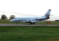 N723QS @ EGGW - This Netjets G200 departs Luton in the gloom for Farnborough - by Terry Fletcher