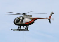N50AP - Easy does it!  The pilot is gingerly maneuvering a component for a powerline into place. - by Daniel L. Berek