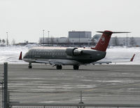 N8604C @ CYOW - NW CRJ leaving the US Departures area, and taxiing to Rwy 32