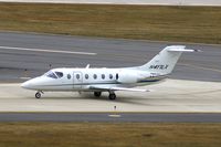 N417LX @ CID - Options 417 taxiing on Alpha after landing Runway 27 - by Glenn E. Chatfield