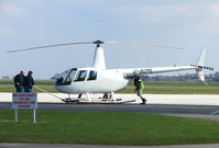 G-BZPL @ EGSH - Robinson R44 being pulled from Hangar to ramp at Norwich UK - by Terry Fletcher