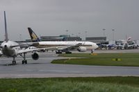 9V-SVC @ EGCC - Taken at Manchester Airport on a typical showery April day - by Steve Staunton