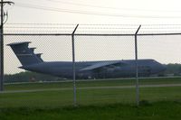 70-0447 @ FFO - C-5A parked on the ramp, as seen from the road through the fence