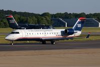 N439AW @ ORF - US Airways Express (operated by Air Wisconsin) N439AW (FLT AWI3976) taxiing to RWY 23 for departure to Philadelphia Int'l (KPHL), while N812EX arrives from Reagan National (KDCA) as FLT PDT4156. - by Dean Heald