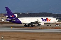 N527FE @ LAX - FedEx N527FE on Taxiway Uniform being escorted by an LAX Airport Operations vehicle while taxiing to the FedEx maintenance hangar. - by Dean Heald