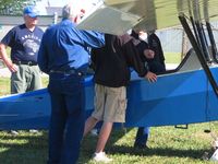 N6186L @ TDZ - Demonstrating how to deplane from the rear seat.  EAA breakfast fly-in at Toledo, OH. - by Bob Simmermon