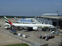 A6-EBV @ EGCC - Emirates B777 surrounded by equipment at Manchester - by Mike stanners