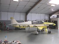 G-AZJN @ EGST - Robin in maintenance hangar at Elmsett - by Simon Palmer