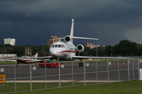 N966H @ ORL - Falcon 900EX with storm in background