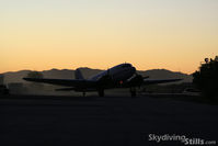 N86584 @ E60 - DC-3 taxies in at sunset. - by Dave G