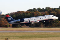 N402AW @ ORF - US Airways Express (Air Wisconsin) N402AW (FLT AWI3652) departing RWY 23 enroute to Reagan National (KDCA). - by Dean Heald