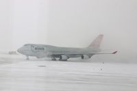 N673US @ CID - NWA9840  taxiing on to Alpha 4 for parking. Snowing with 25-30kt wind blowing snow. - by Glenn E. Chatfield