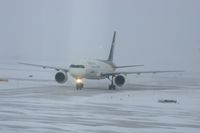 N414UP @ CID - Taxiing to cargo ramp via Alpha 4.  Early morning in the snow. - by Glenn E. Chatfield