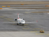 OE-LCQ @ VIE - Returning from a flight - taxiing to parking position lead by the follow me car - by Patrick Radosta