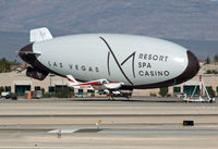N8831W @ VGT - Cherokee 31W flies past the M Blimp - by Geoff Smith